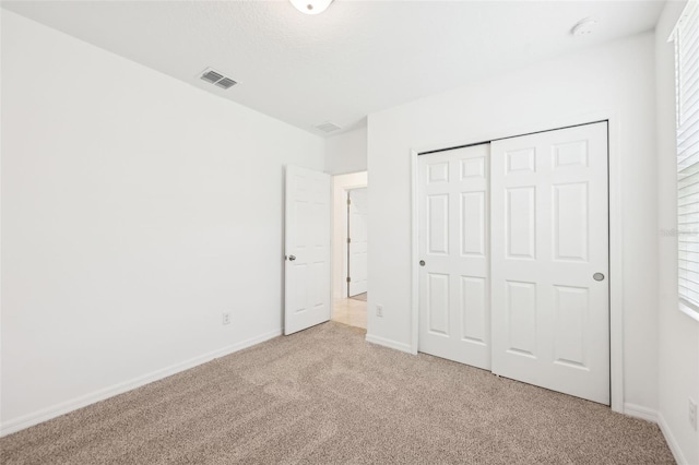 4717 Jasmine Cir, Leesburg, FL 34748 - unfurnished bedroom featuring carpet flooring, baseboards, a closet, and multiple windows
