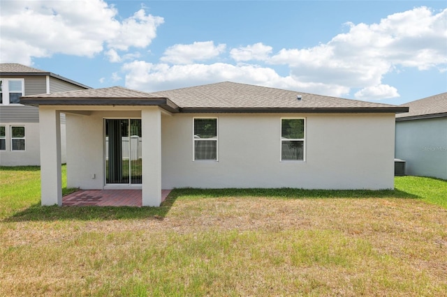 4717 Jasmine Cir, Leesburg, FL 34748 - back of house featuring stucco siding, a lawn, and a shingled roof