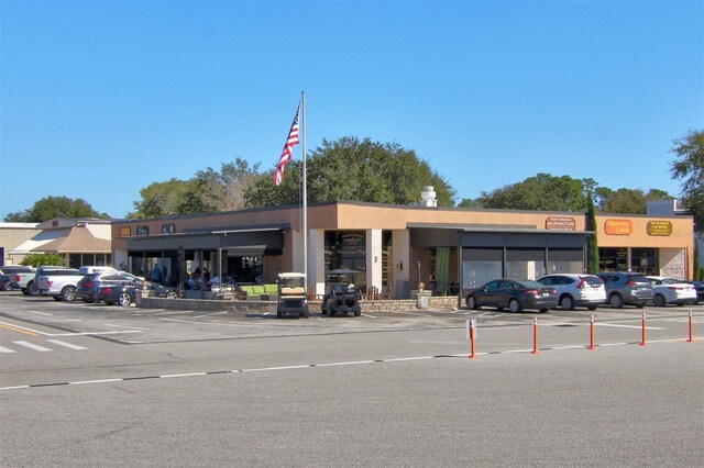 view of building exterior featuring uncovered parking