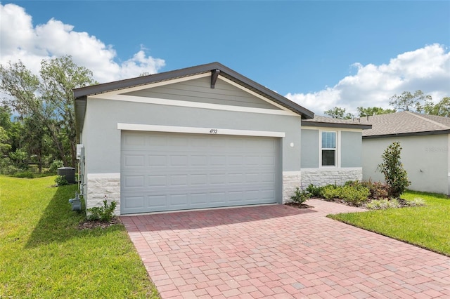 4732 Jasmine Cir, Leesburg, FL 34748 - ranch-style home featuring stone siding, decorative driveway, a front yard, and cooling unit