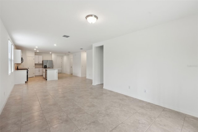 4732 Jasmine Cir, Leesburg, FL 34748 - unfurnished living room with light tile patterned floors, recessed lighting, and baseboards