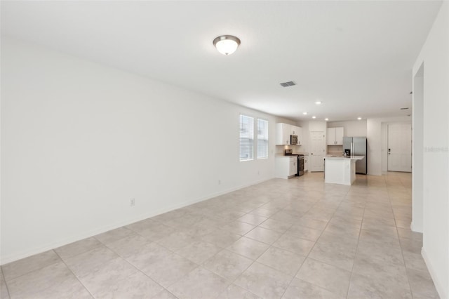 4732 Jasmine Cir, Leesburg, FL 34748 - unfurnished living room featuring recessed lighting, baseboards, and light tile patterned floors