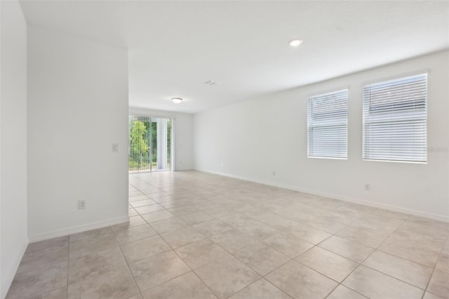 4732 Jasmine Cir, Leesburg, FL 34748 - spare room with light tile patterned flooring and baseboards