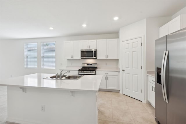 4732 Jasmine Cir, Leesburg, FL 34748 - kitchen with stainless steel appliances, a sink, white cabinetry, a center island with sink, and recessed lighting