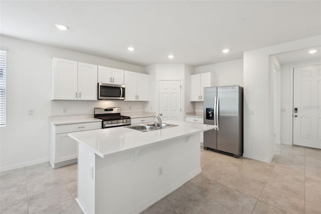 4732 Jasmine Cir, Leesburg, FL 34748 - kitchen with appliances with stainless steel finishes, white cabinets, a sink, light countertops, and an island with sink
