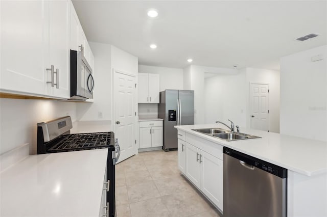 4732 Jasmine Cir, Leesburg, FL 34748 - kitchen with stainless steel appliances, a sink, white cabinetry, a kitchen island with sink, and recessed lighting