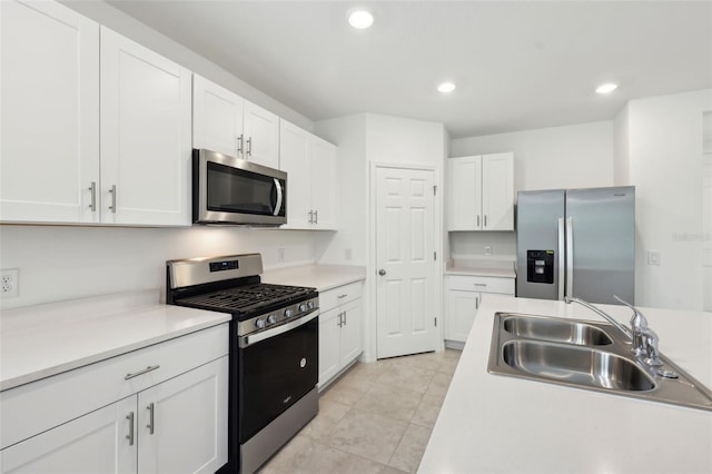4732 Jasmine Cir, Leesburg, FL 34748 - kitchen with appliances with stainless steel finishes, a sink, white cabinets, light countertops, and recessed lighting