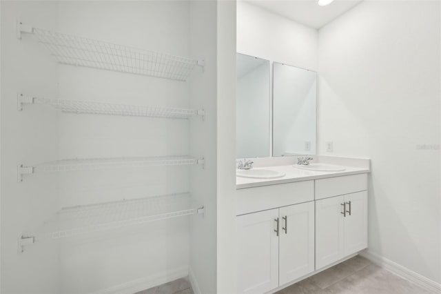 4732 Jasmine Cir, Leesburg, FL 34748 - full bathroom with baseboards, double vanity, and tile patterned flooring
