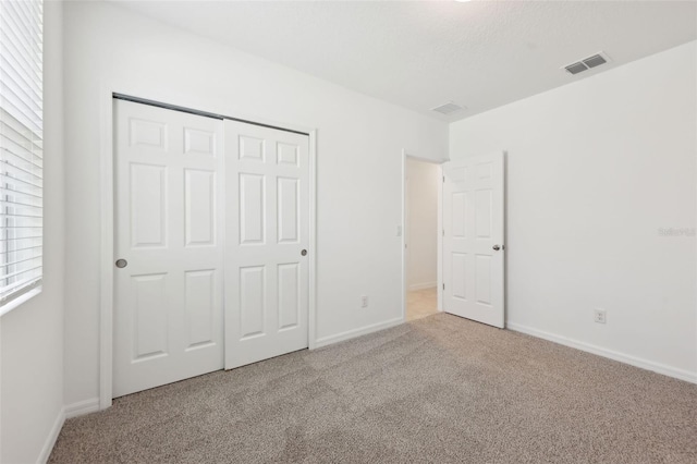 4732 Jasmine Cir, Leesburg, FL 34748 - unfurnished bedroom with carpet, a closet, and baseboards