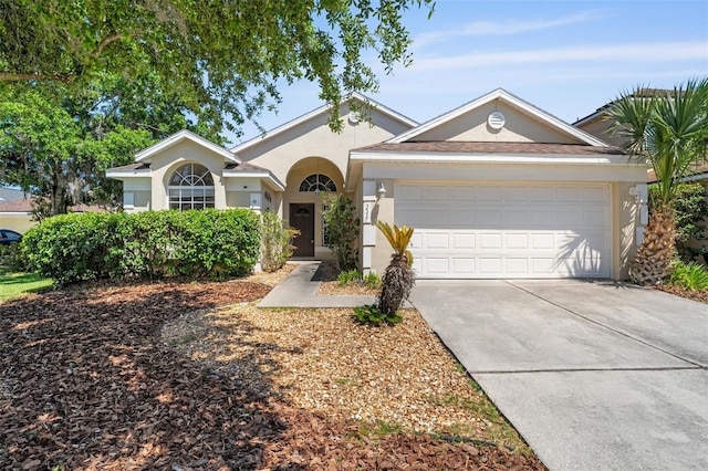 ranch-style house featuring stucco siding, driveway, and a garage