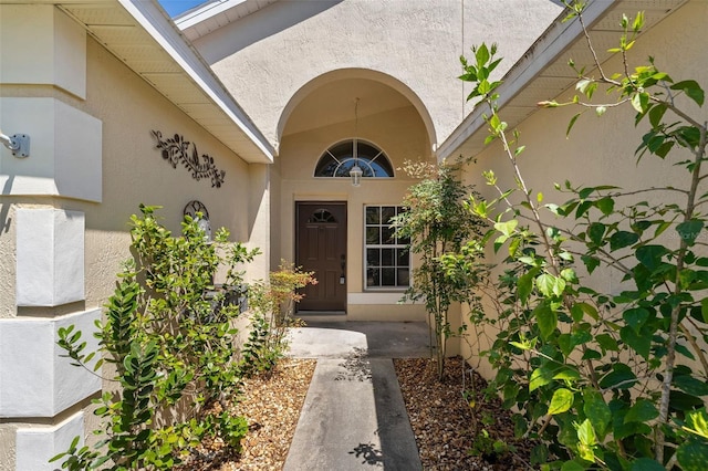 property entrance featuring stucco siding