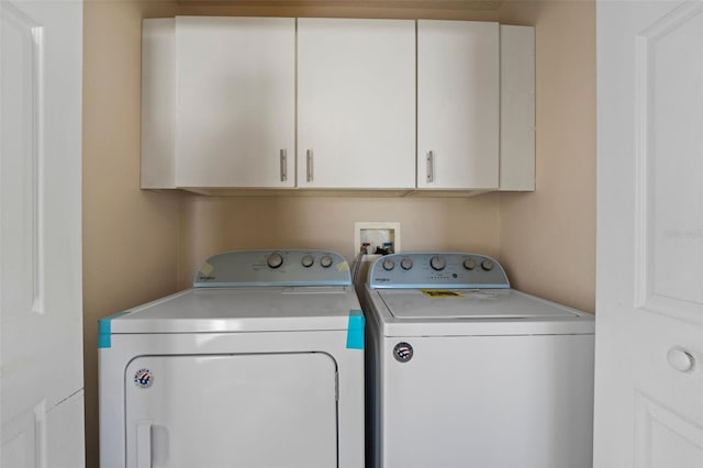 laundry area featuring washer and dryer and cabinet space
