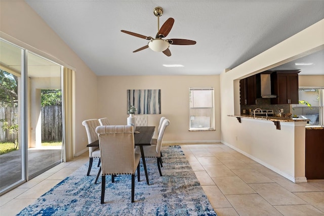 dining area featuring baseboards, a ceiling fan, and light tile patterned floors
