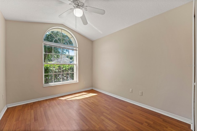 unfurnished room featuring lofted ceiling, a ceiling fan, wood finished floors, and baseboards