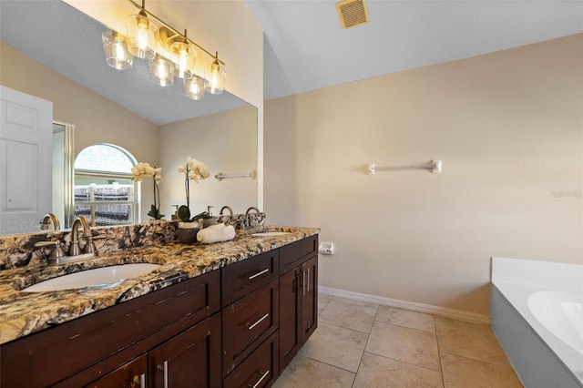 full bathroom featuring a bath, double vanity, visible vents, and a sink