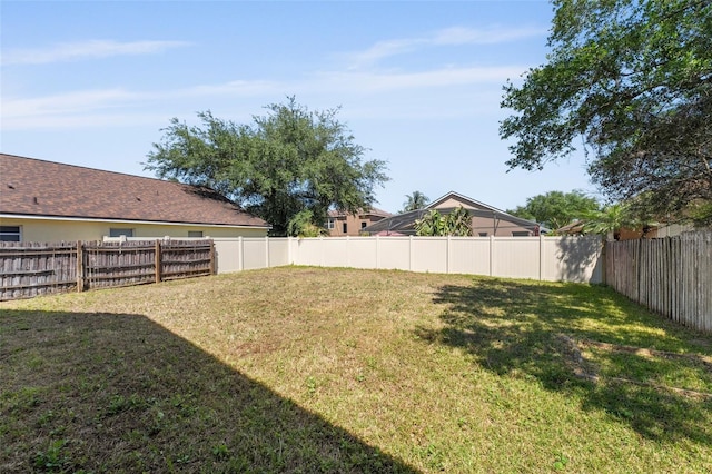 view of yard with a fenced backyard