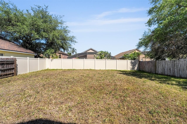 view of yard with a fenced backyard
