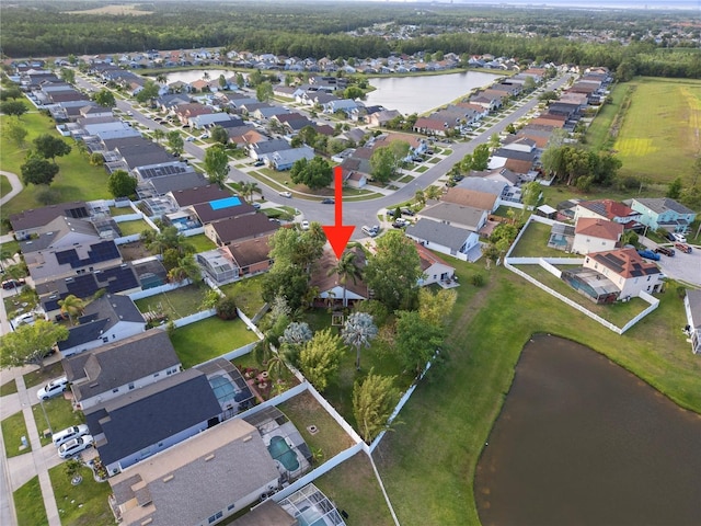 drone / aerial view with a residential view and a water view
