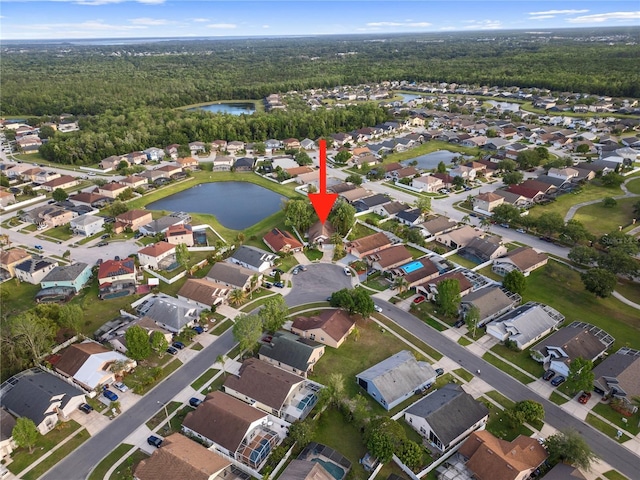aerial view featuring a forest view, a water view, and a residential view