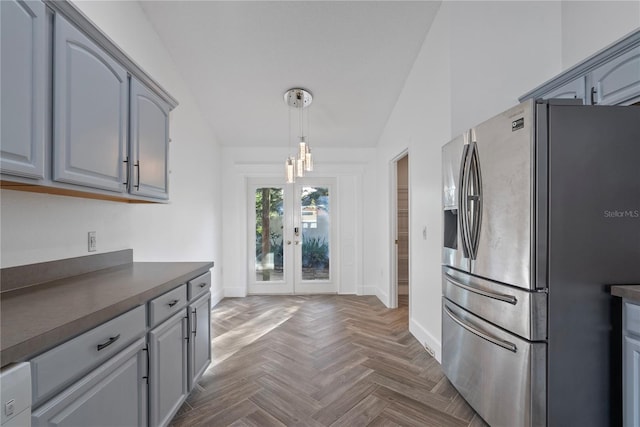 kitchen featuring stainless steel fridge with ice dispenser, dark countertops, french doors, baseboards, and gray cabinetry