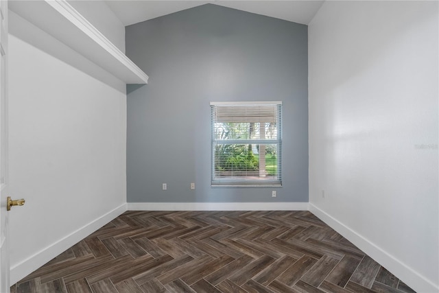 unfurnished room with high vaulted ceiling and baseboards