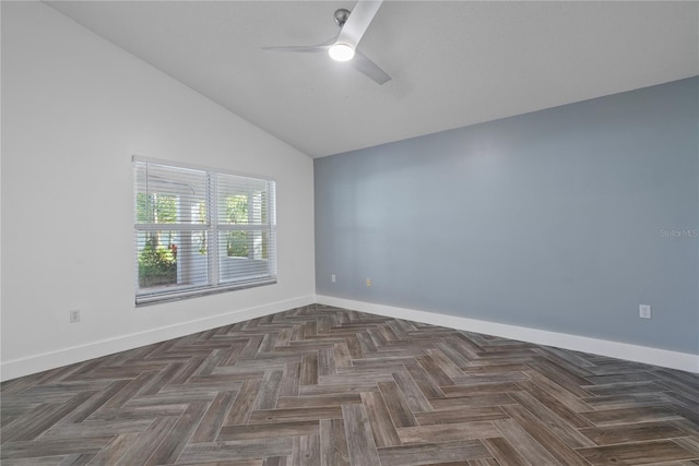 empty room featuring lofted ceiling, baseboards, and ceiling fan