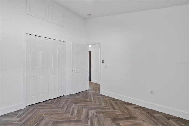 unfurnished bedroom with baseboards and a closet
