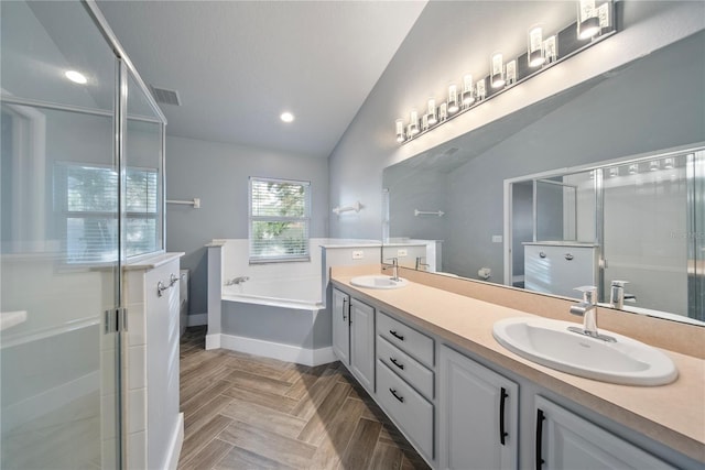 bathroom featuring double vanity, lofted ceiling, a shower stall, and a sink