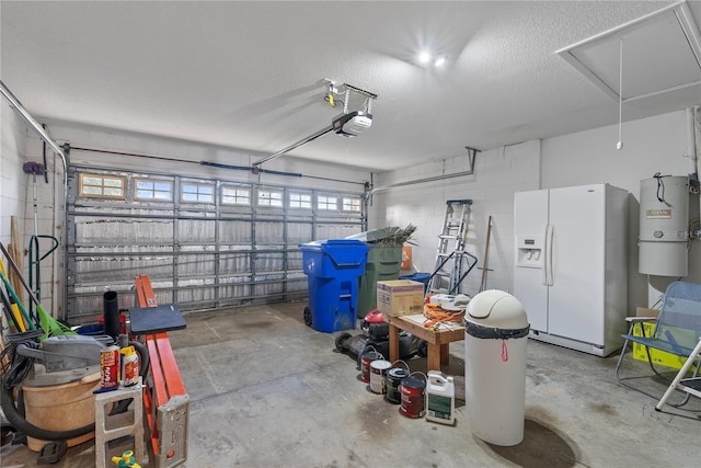 garage featuring concrete block wall, a garage door opener, and white fridge with ice dispenser