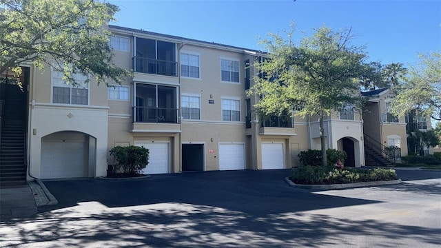 5125 Palm Springs Blvd Unit 13107, Tampa, FL 33647 - exterior space with a garage, driveway, and stucco siding