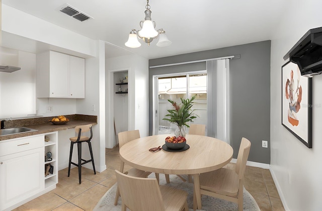 dining area with visible vents, baseboards, an inviting chandelier, and light tile patterned flooring