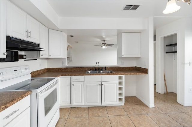 kitchen with under cabinet range hood, white range with electric stovetop, a sink, and dark countertops