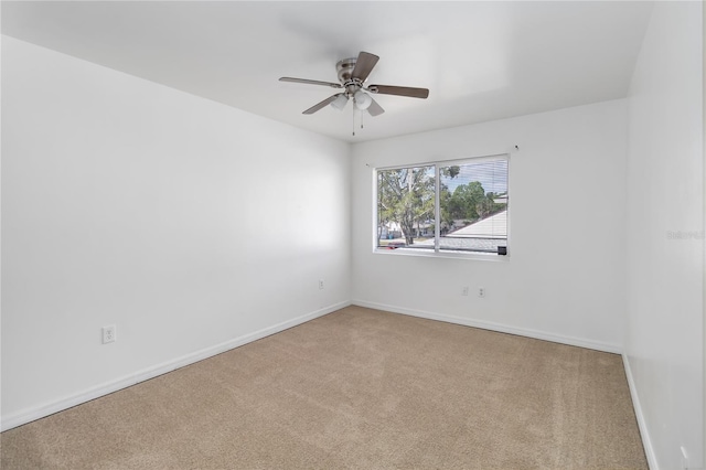 spare room featuring carpet, baseboards, and ceiling fan