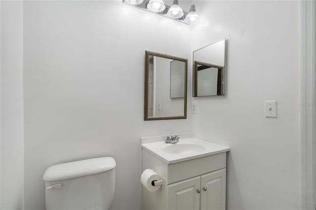 bathroom featuring toilet and vanity