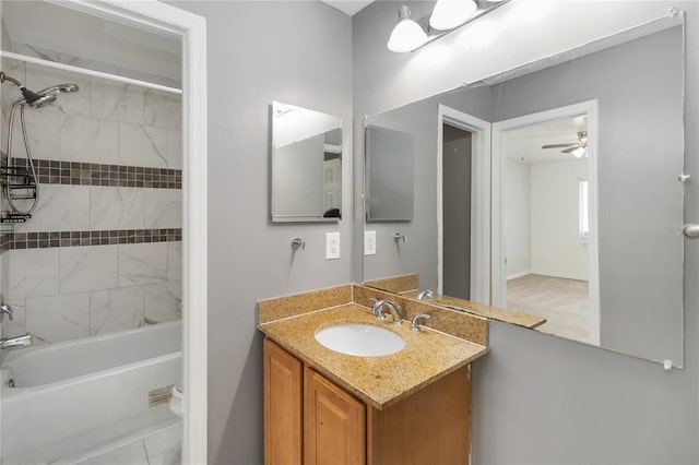 bathroom featuring vanity, shower / tub combination, and ceiling fan