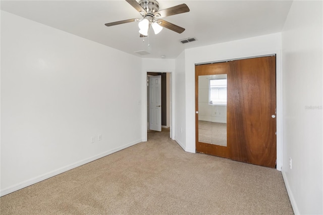 unfurnished bedroom with carpet, visible vents, baseboards, and a ceiling fan
