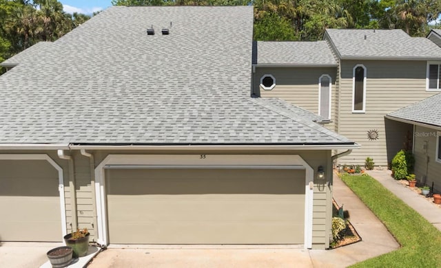 35 Misners Trl, Ormond Beach, FL 32174 - view of front of home featuring an attached garage, a shingled roof, and driveway