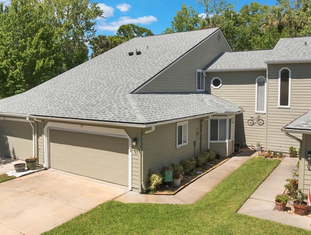 35 Misners Trl, Ormond Beach, FL 32174 - view of front of home featuring driveway, a shingled roof, a front yard, and a garage