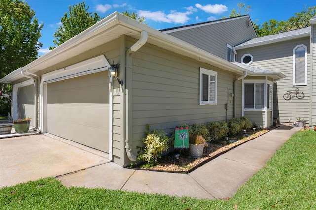 35 Misners Trl, Ormond Beach, FL 32174 - view of home's exterior featuring concrete driveway and an attached garage