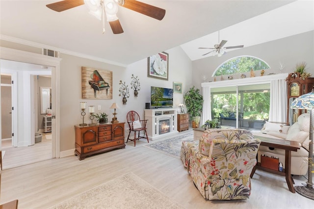 35 Misners Trl, Ormond Beach, FL 32174 - living room with a ceiling fan, light wood-type flooring, a glass covered fireplace, high vaulted ceiling, and baseboards