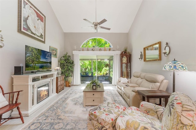 35 Misners Trl, Ormond Beach, FL 32174 - living area featuring high vaulted ceiling, ceiling fan, a glass covered fireplace, and light wood-style flooring