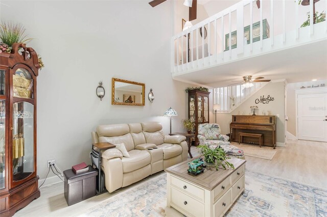 35 Misners Trl, Ormond Beach, FL 32174 - living area featuring ceiling fan, a towering ceiling, light wood finished floors, and baseboards