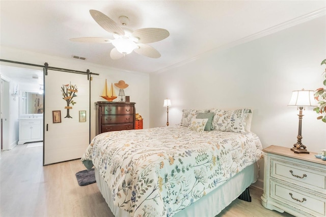 35 Misners Trl, Ormond Beach, FL 32174 - bedroom featuring light wood-style floors, ornamental molding, a barn door, and ceiling fan