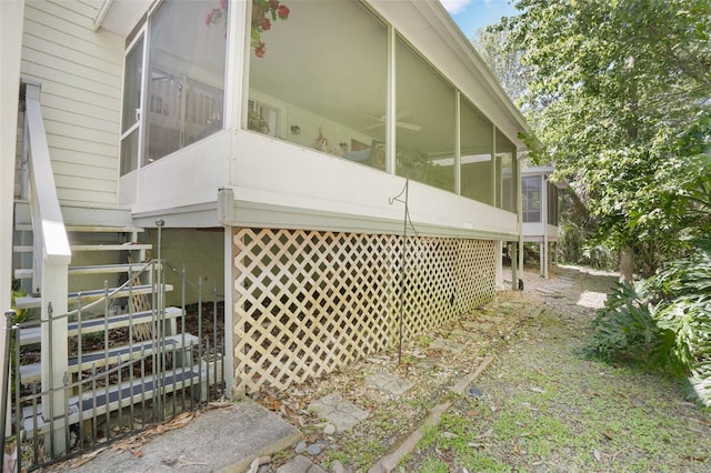 35 Misners Trl, Ormond Beach, FL 32174 - view of side of home featuring a sunroom and stairway