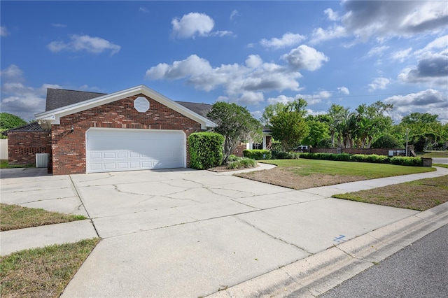 view of front of home featuring a front lawn, brick siding, driveway, and a garage