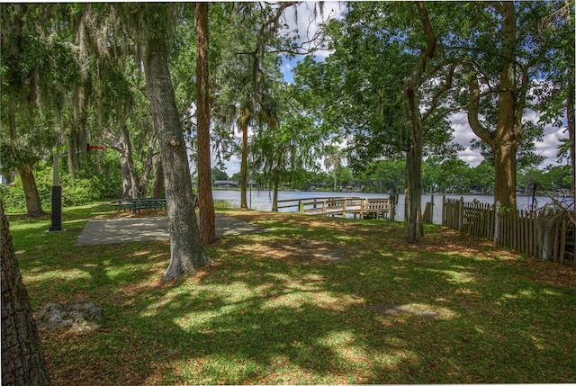 view of yard featuring a water view and fence