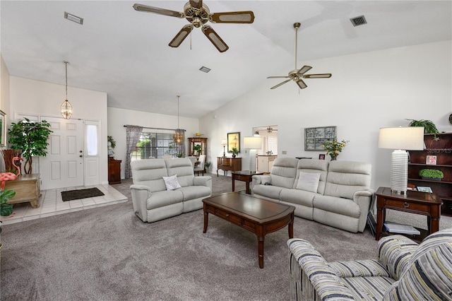 living room with high vaulted ceiling, ceiling fan, carpet floors, and visible vents