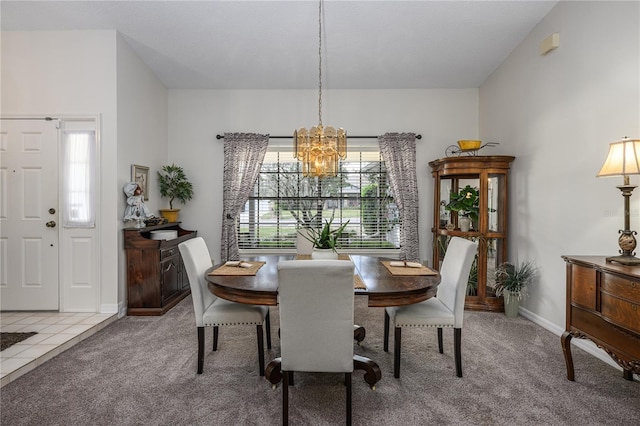 dining room featuring carpet, baseboards, and an inviting chandelier