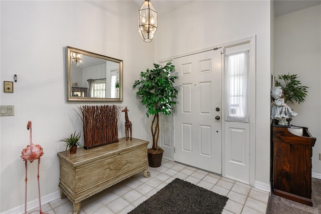 foyer with baseboards and light tile patterned floors