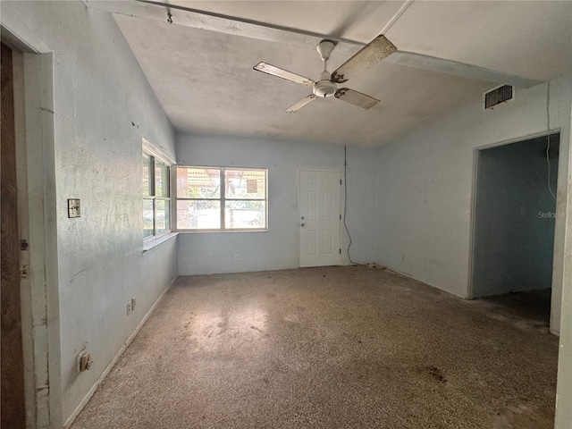 unfurnished room with a ceiling fan and visible vents
